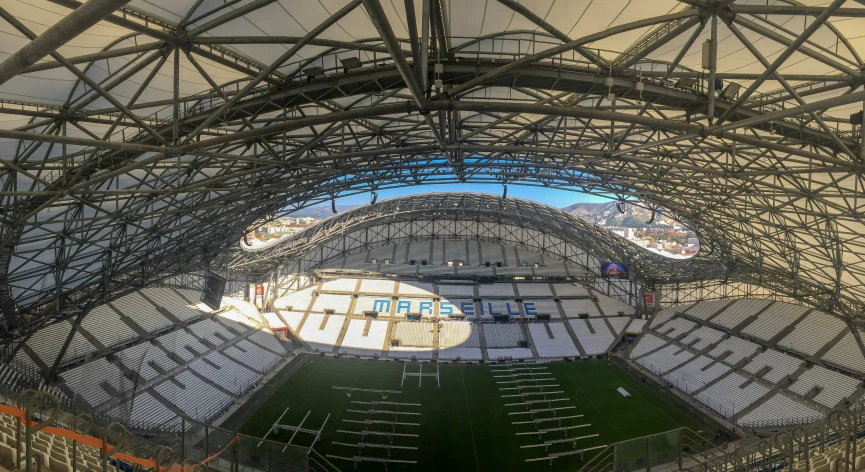 an empty soccer stadium with multiple seats and a roof