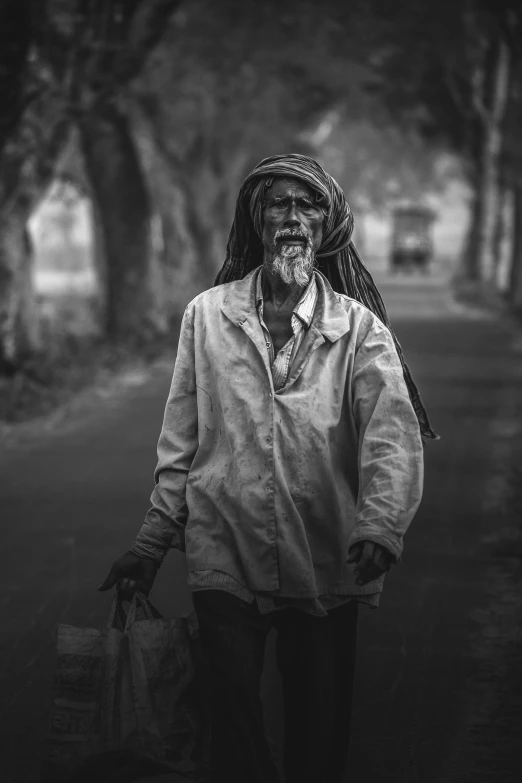 a man carrying a bag walking down the road