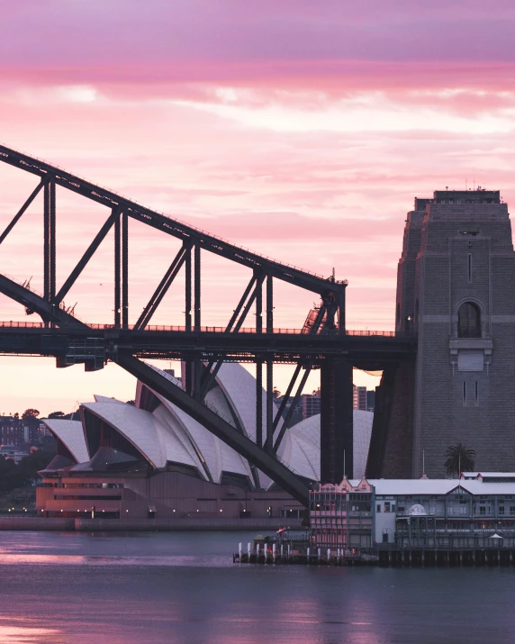 the sun is setting over the city in sydney