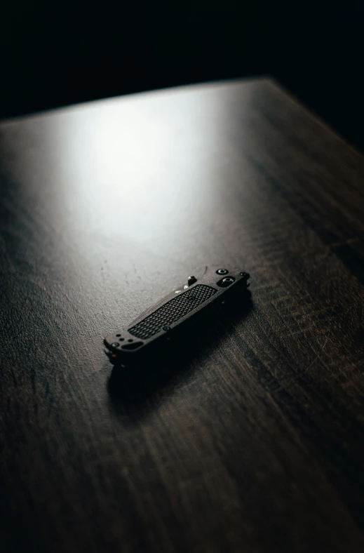 an old remote control laying on a wooden table