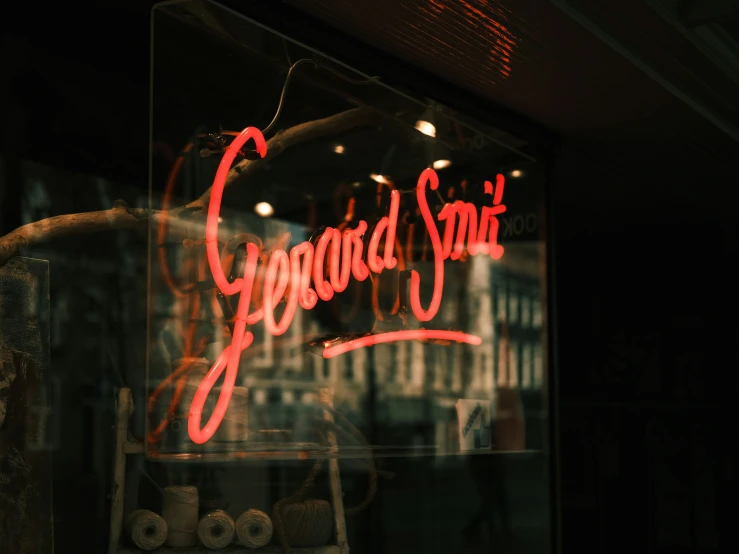 a neon sign in a shop front window