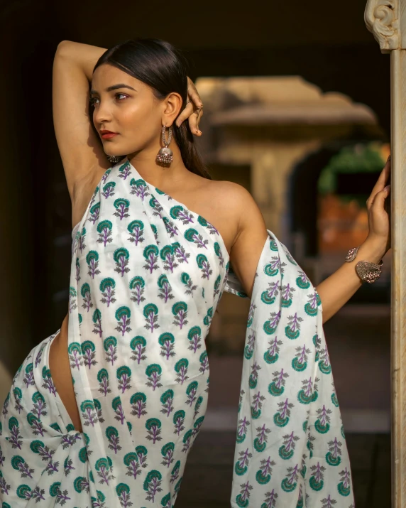 a beautiful woman posing with her arms behind her back