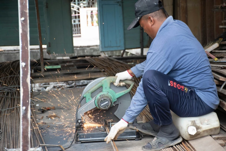 a man using a circular saw to cut through wood