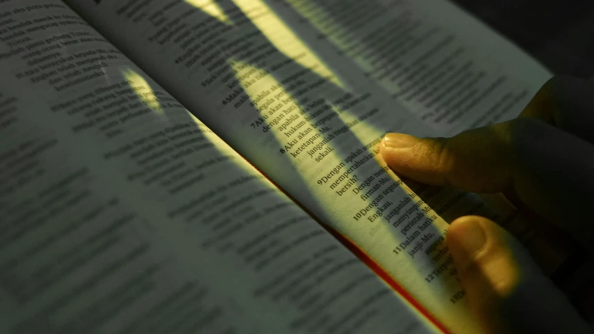 hands typing on a book with their fingers