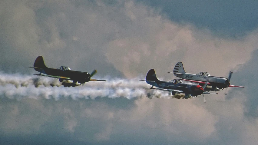 two planes in the sky with vapor trails