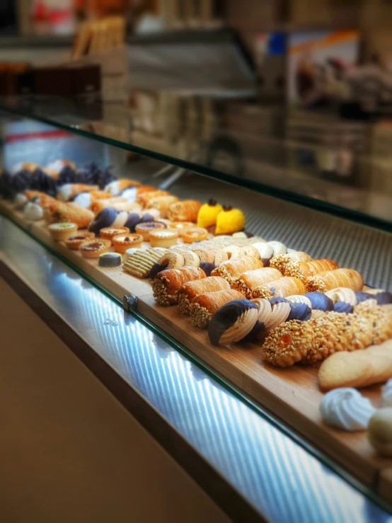 a glass display case filled with assorted treats