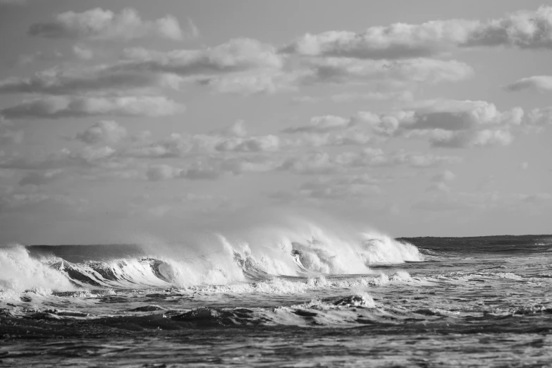 black and white pograph of large crashing waves