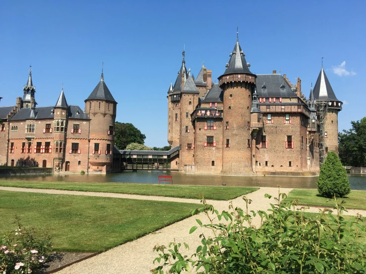 an ornate castle like structure stands on a body of water