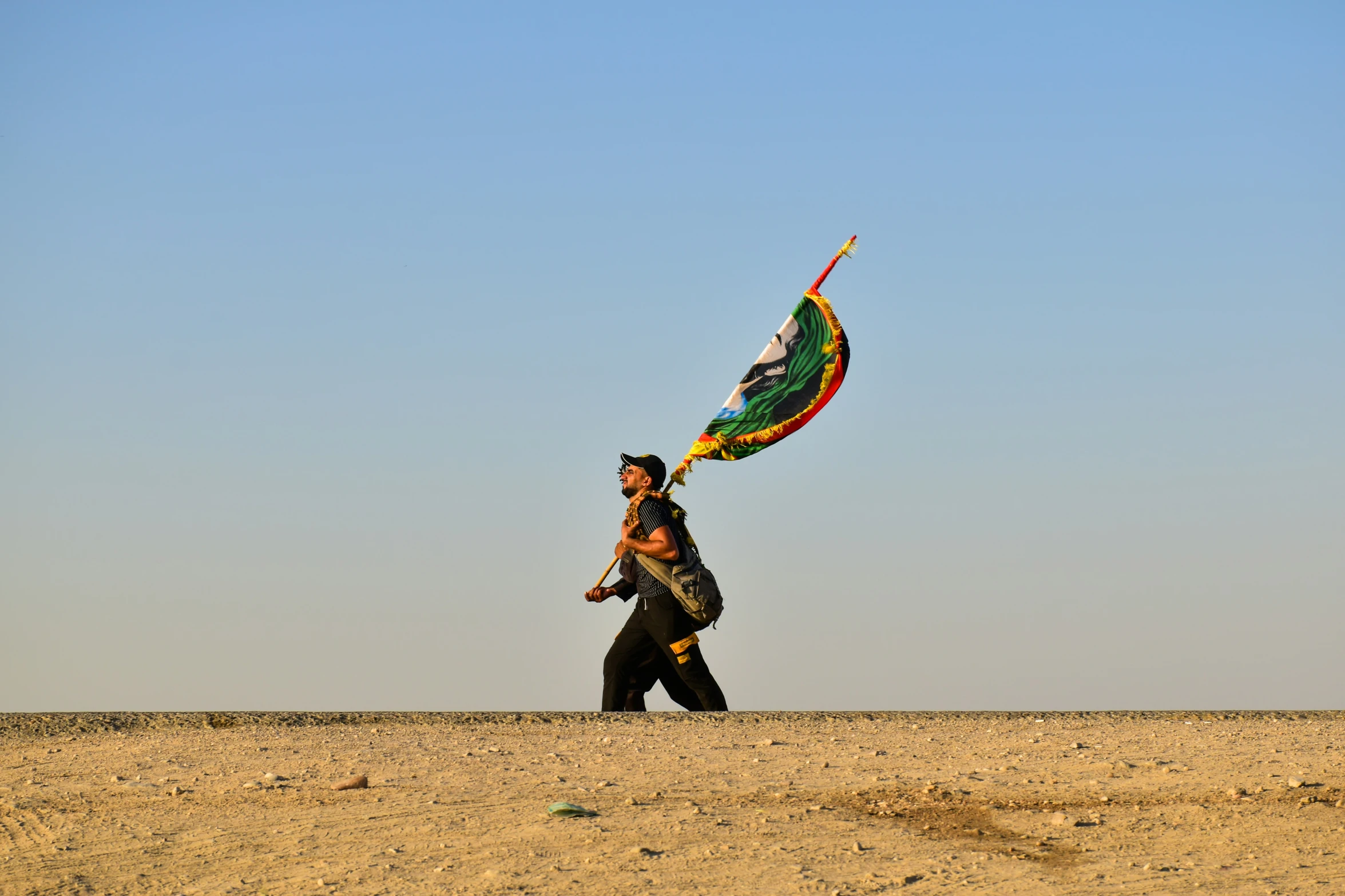 person holding a flag and waving a kite