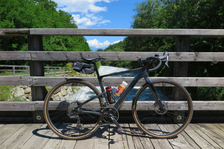 a road bike parked in front of a wooden bridge