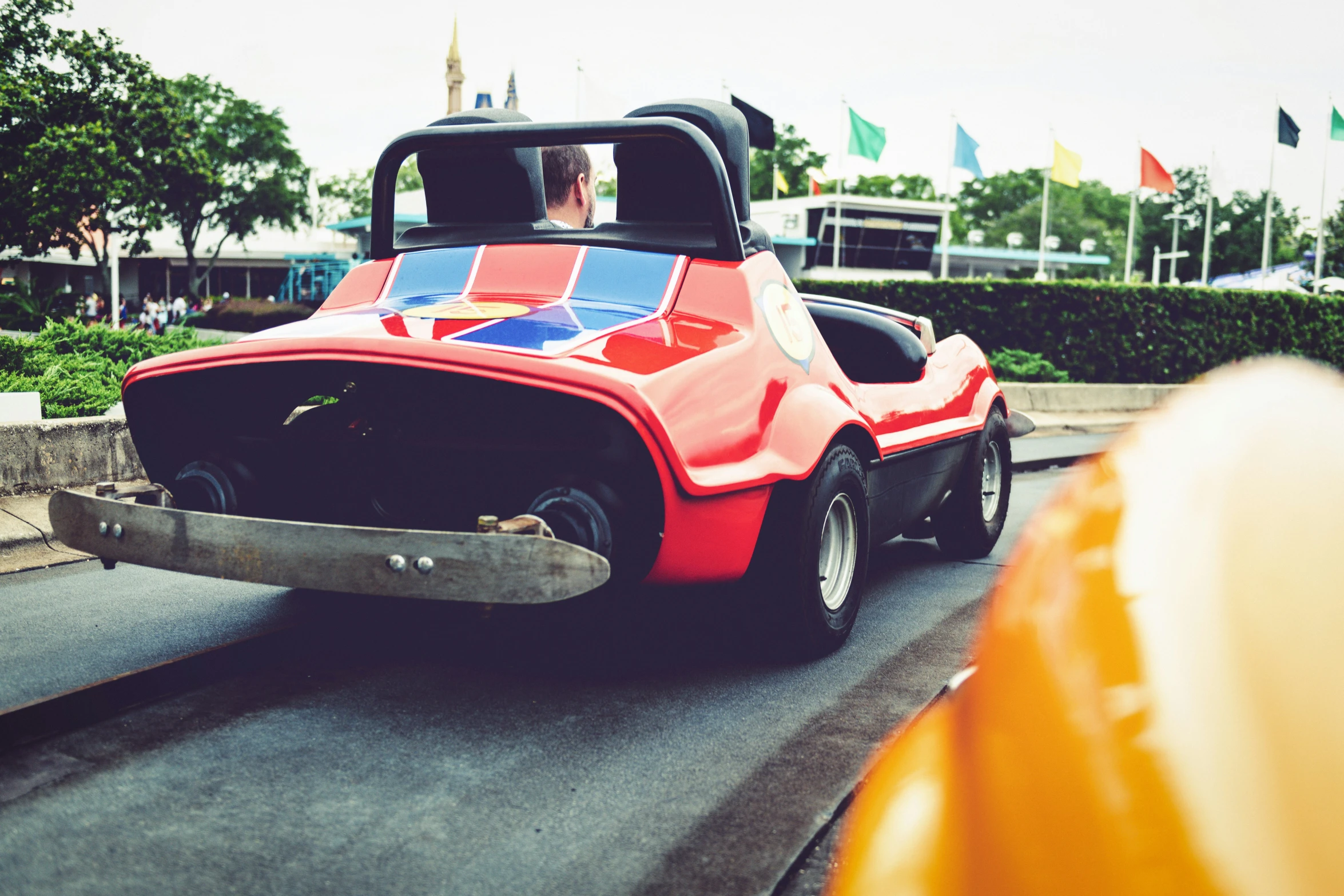 people are riding in a very small car with wheels