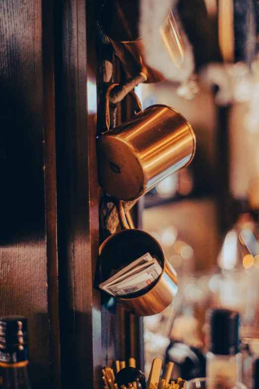 a close up of cups on rack by bottle