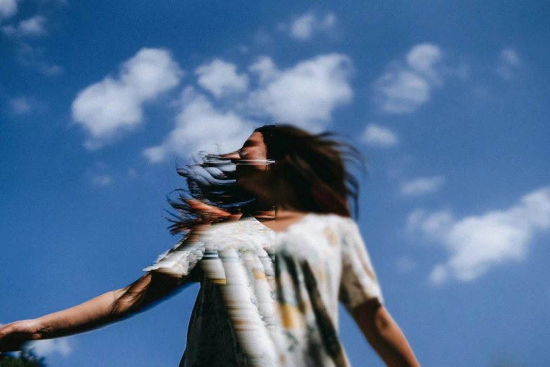 a woman flying a kite high in the sky