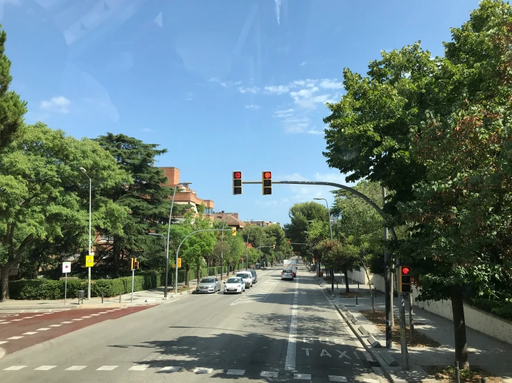 the sun shines on a tree lined street