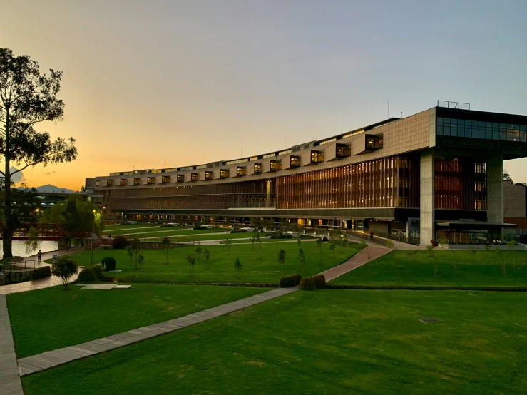 an overview of a large building with green grass