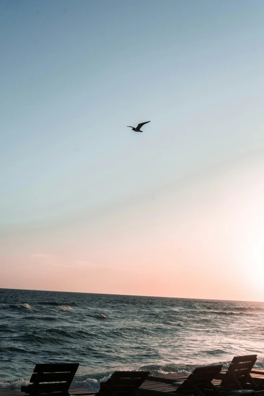 a plane is flying in the sky over the water