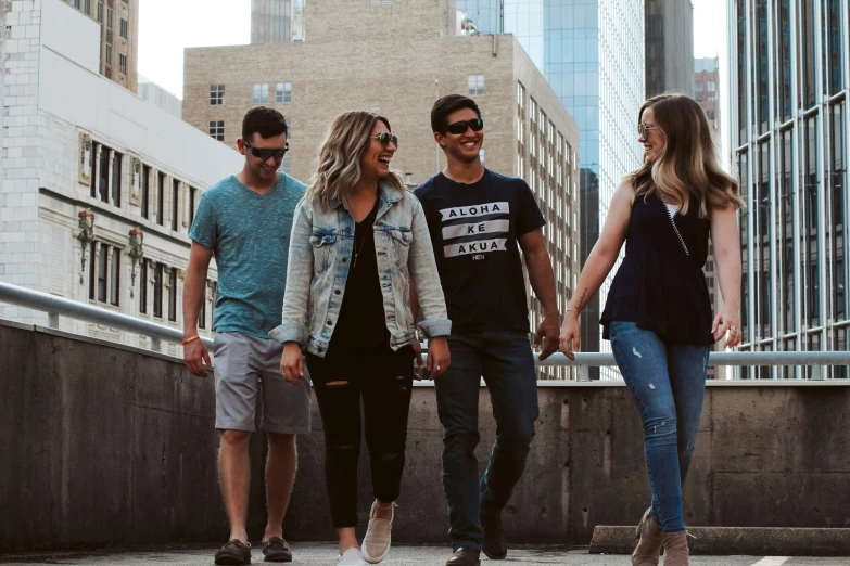 people walk down a bridge holding hands