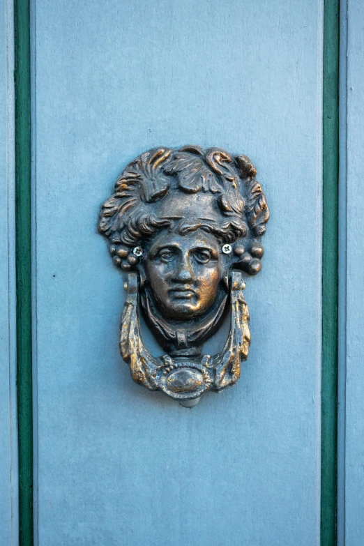 close up of a statue mounted on a door