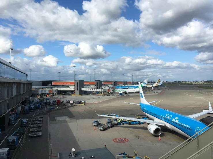 an air plane sitting on a runway near a terminal