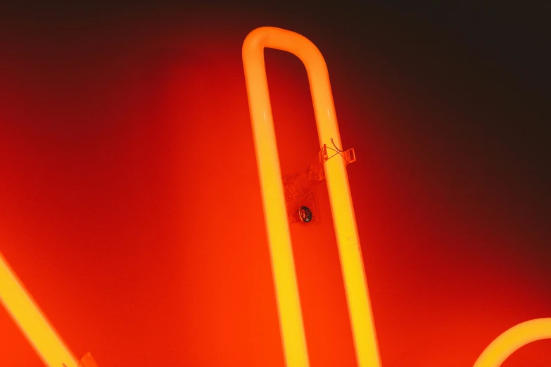 a neon sign that looks like a tube and has a stick