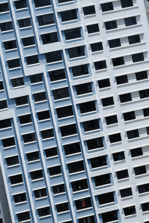 a very tall grey building with several windows