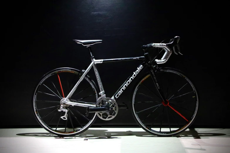 a bike is standing against a dark background