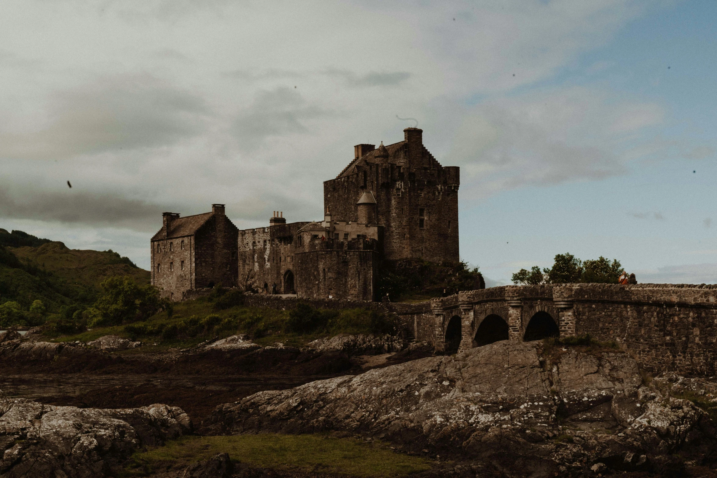 a castle is sitting on top of the rocks