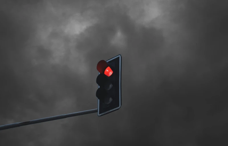 a traffic light with a red signal attached