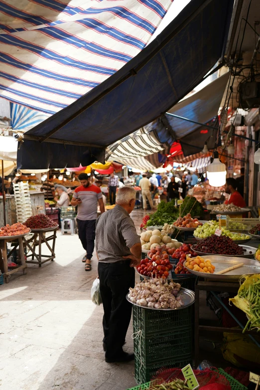 a couple of people walking around a market