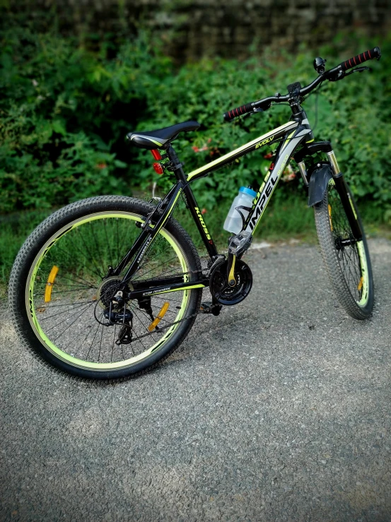 a black and yellow bike parked on the side of the road