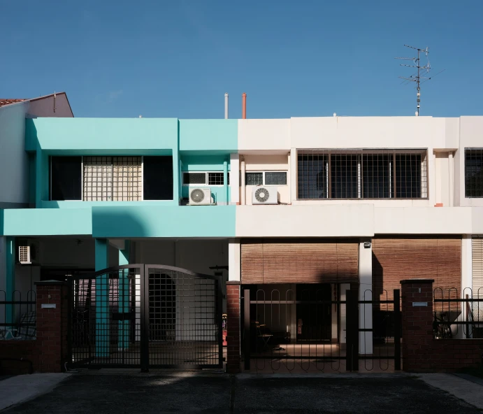 two identical homes side by side, one with a blue and white painted exterior