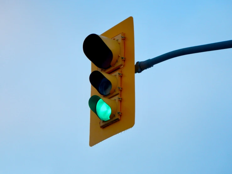 two green stoplights with no signal wires