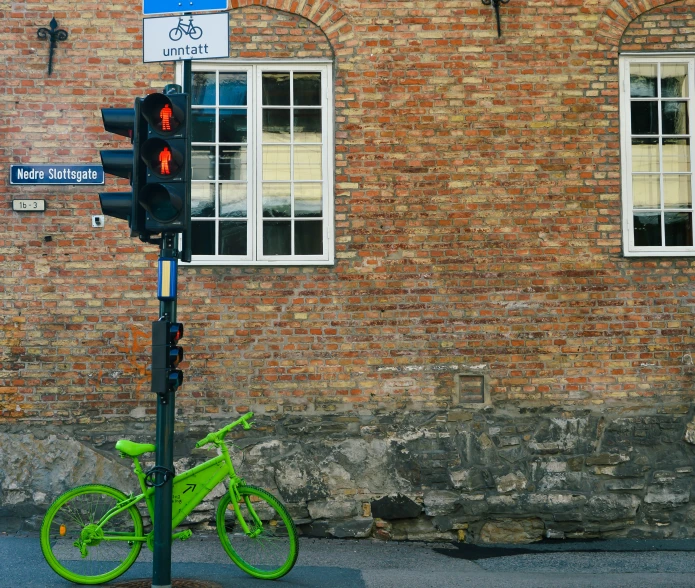 a bicycle parked next to a traffic light