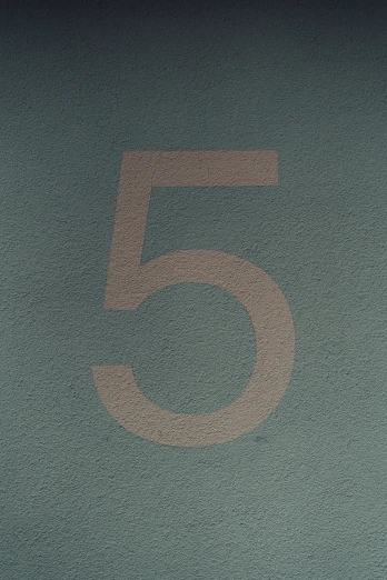 a white and gray number 5 is placed over a blue background
