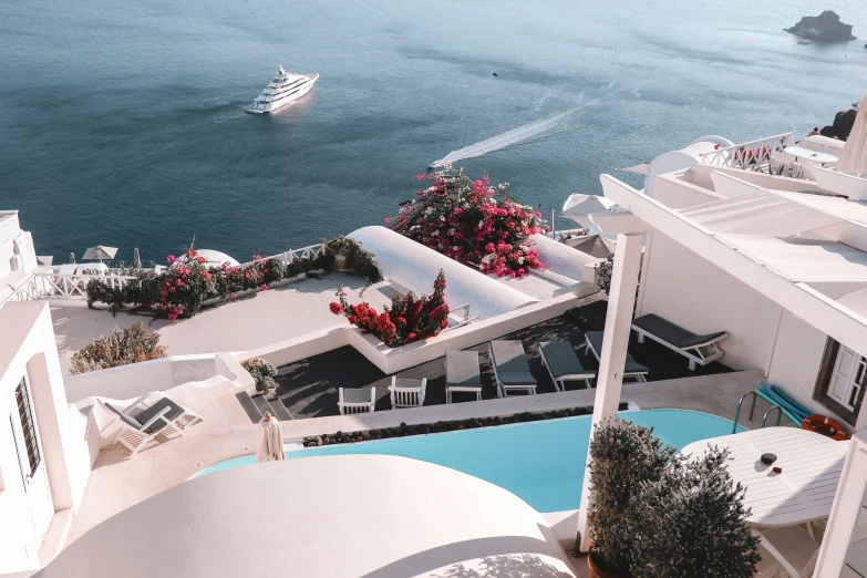 an aerial view of the pool area and ocean from atop of a el