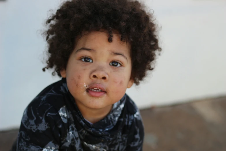 a little boy with freckles on his face