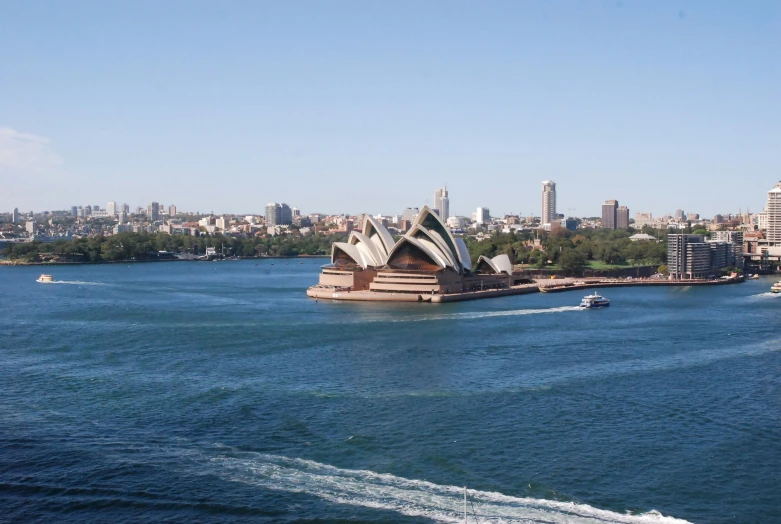 the opera house, sydney bridge and ferries, on a beautiful day