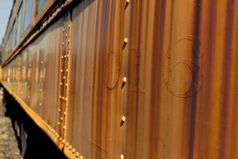 the rear of a rusty train is painted orange