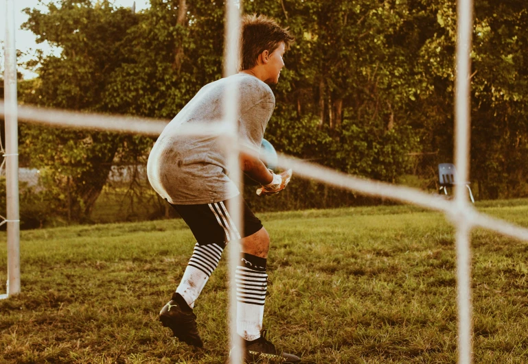 young man preparing to catch the frisbee during the day