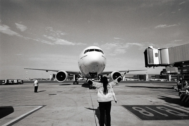 black and white pograph of woman with airplane