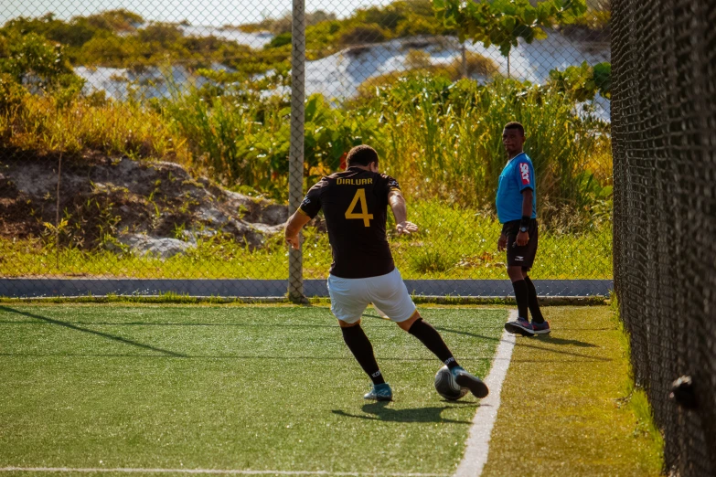 a soccer player in blue and black going after the ball
