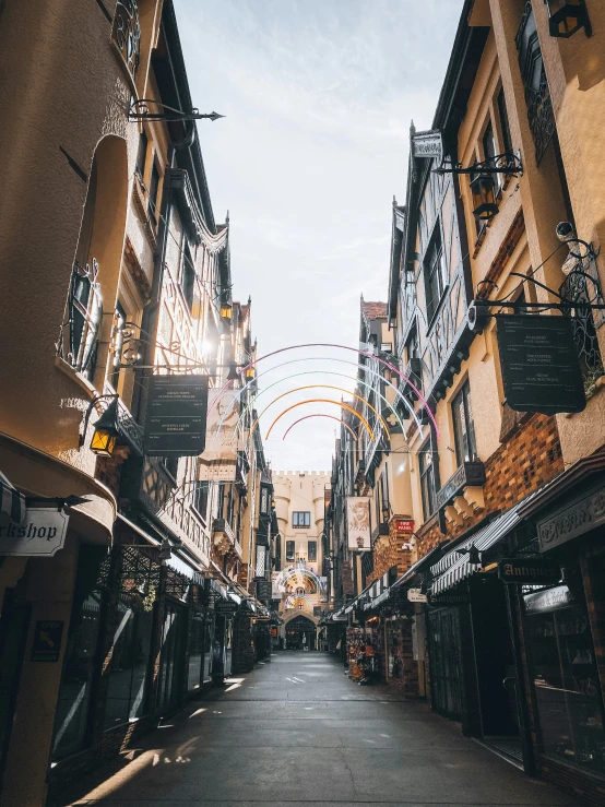 a narrow city street with lots of businesses