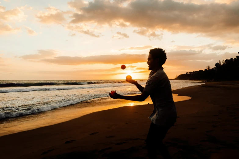 a person standing on a beach throwing a ball