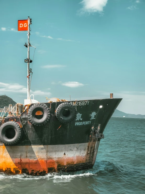 an old boat is in the water near a pier