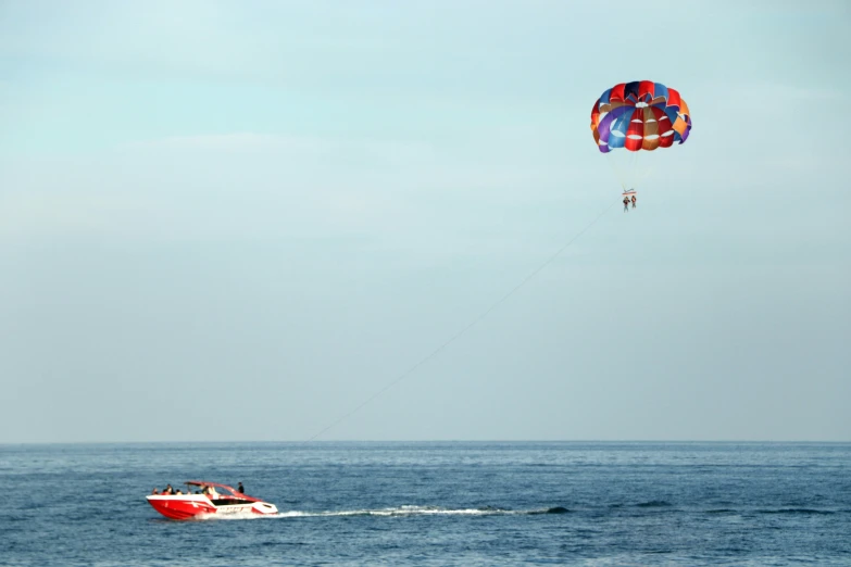 people are in the ocean on a parasail