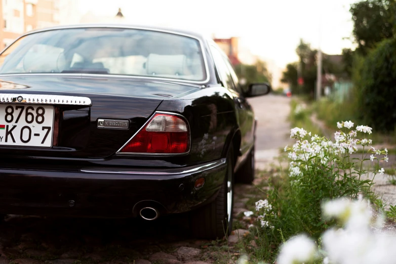 a black car parked in front of a road