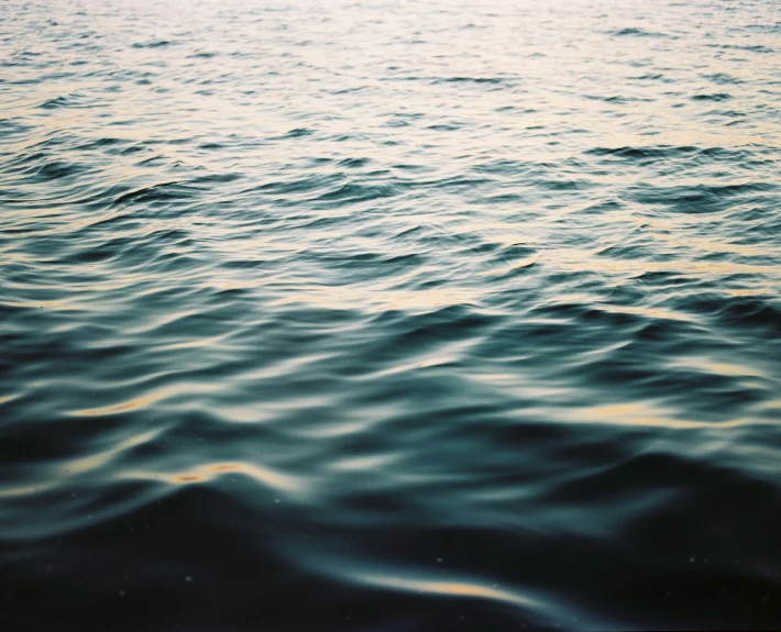 a view from the ocean of rough water and a few waves