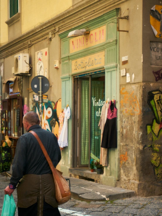 a street corner with two ladies looking into a shop window