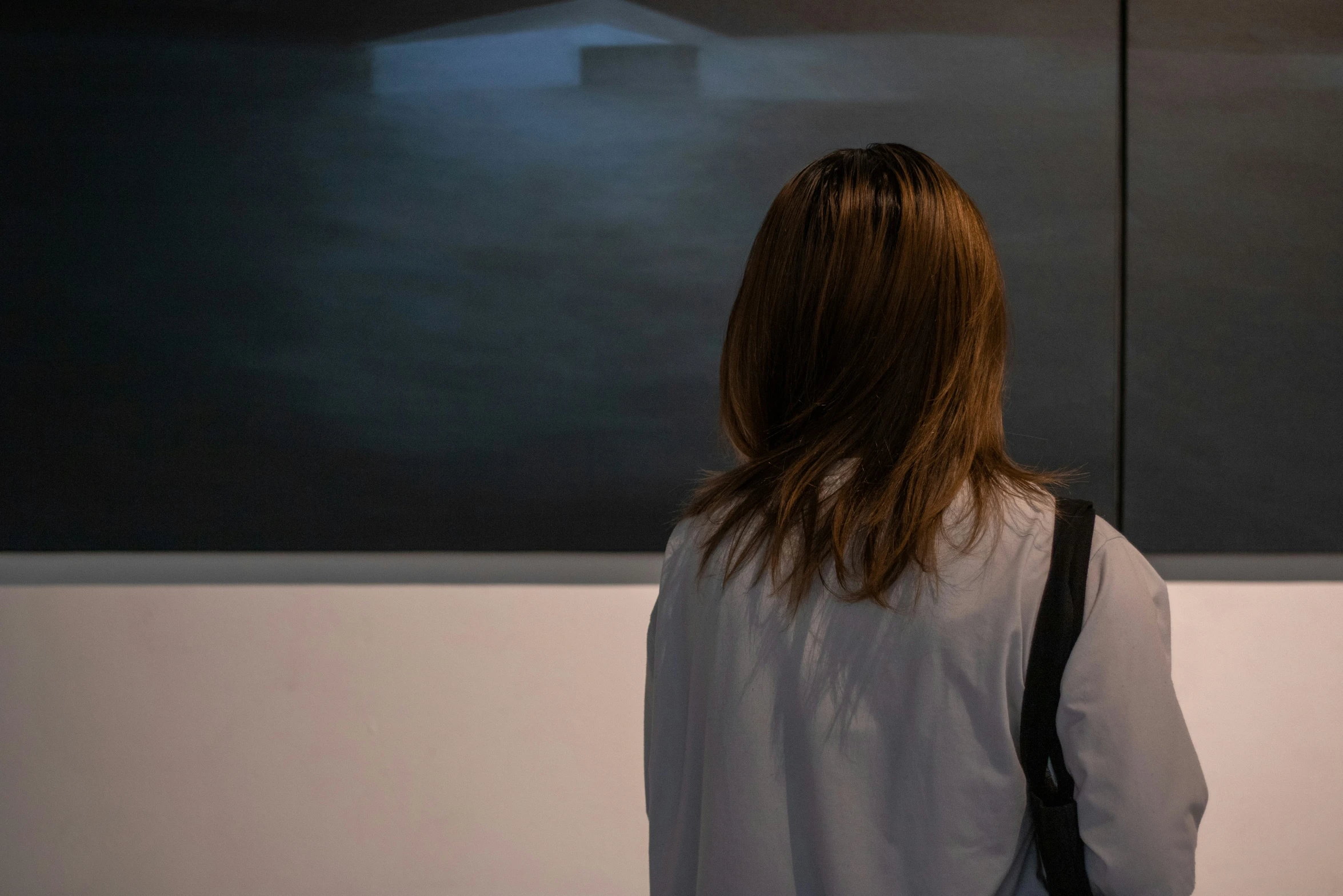 a woman looking at the sky on a wall