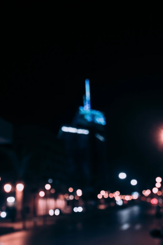 traffic lights in the night near a city skyline